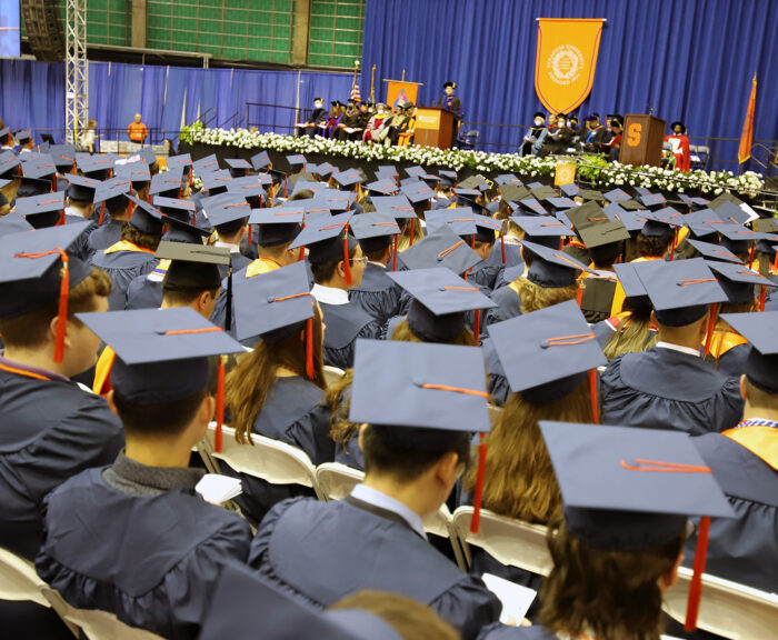 A crowd of engineering and computer science graduates sitting in chairs