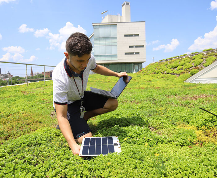 Student collecting data on the green roof