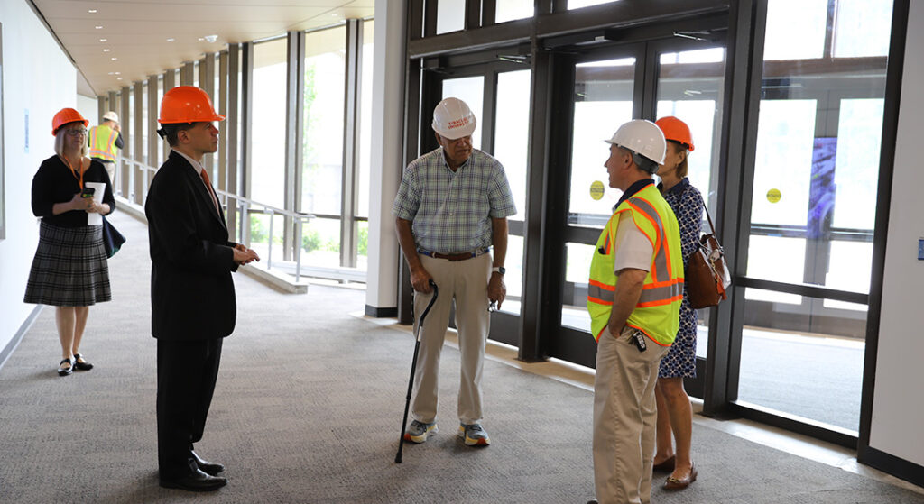 Bill Allyn talking with Dean Smith and College Leadership in the new west lobby of Link Hall