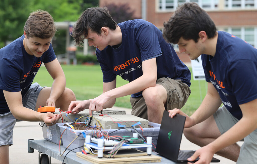 Brendan Murty, Matthew Brewster and Ian Storrs working on a prototype during Invent@SU