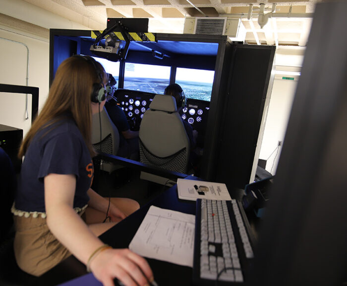 Students flying in the Syracuse University Flight Simulator