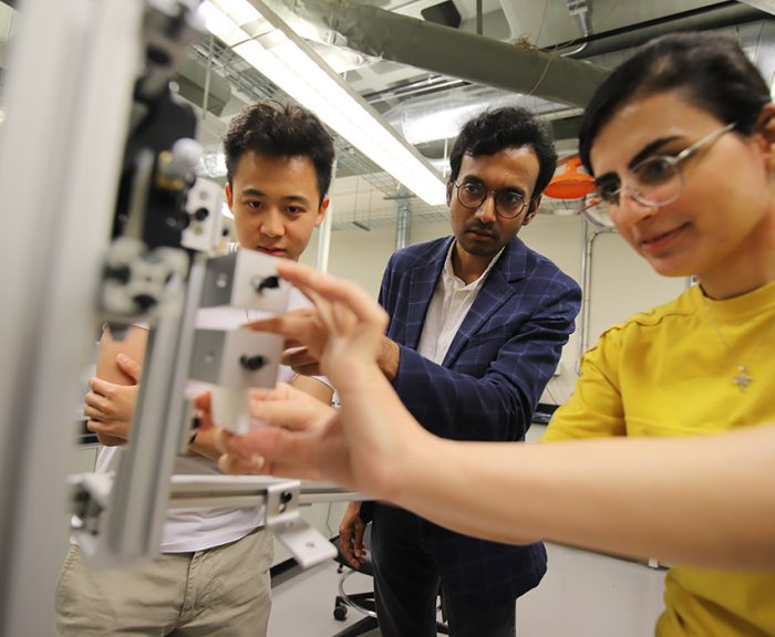 Mechanical and Aerospace Engineering Professor Anupam Pandey and two students work on a research project