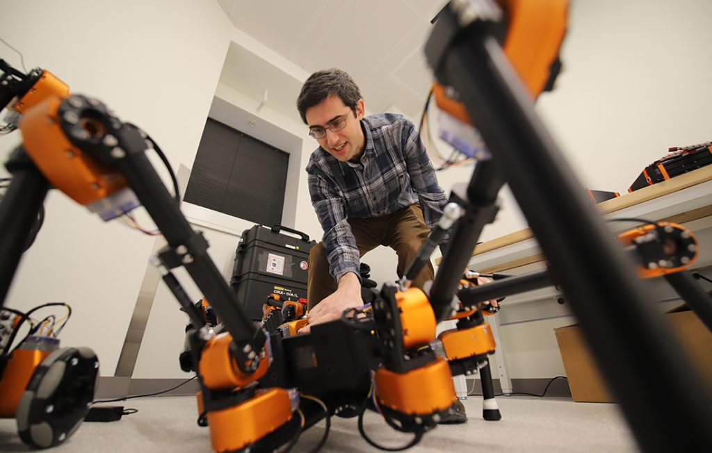 Professor Garrett Katz working with an autonomous robot