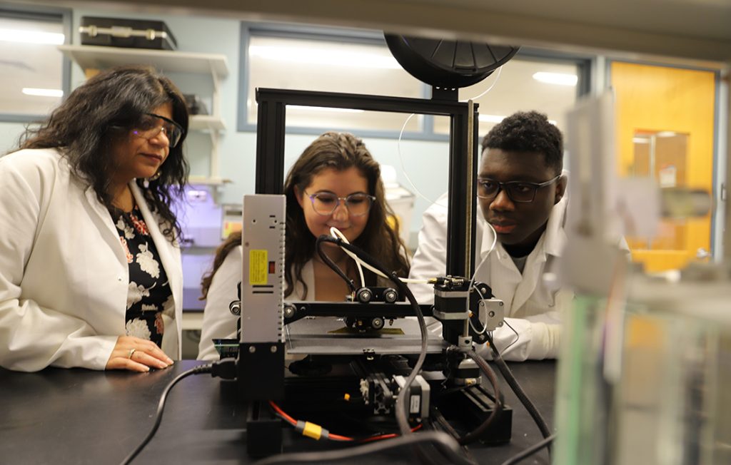 Professor Shikha Nangia and two students conducting research in a BioInspired Institute lab