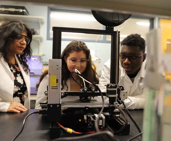 Professor Shikha Nangia and two students conducting research in a BioInspired Institute lab
