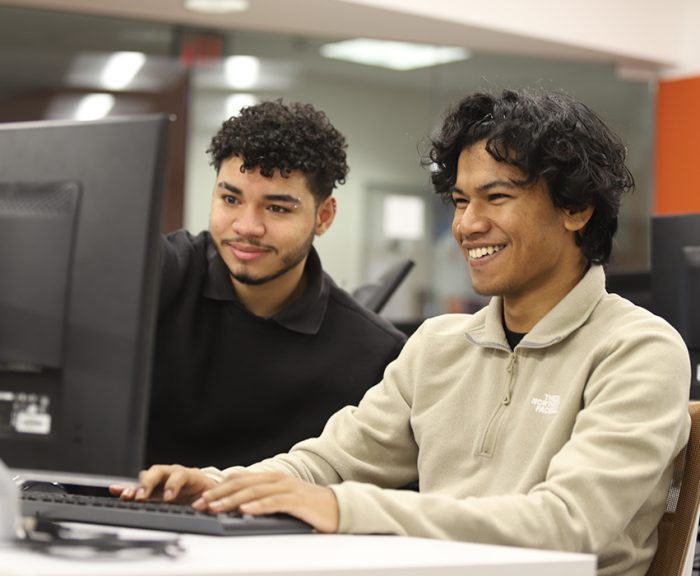 Two students working on a computer project