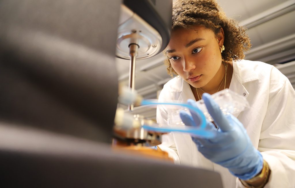 A biomedical and chemical engineering student working in a laboratory