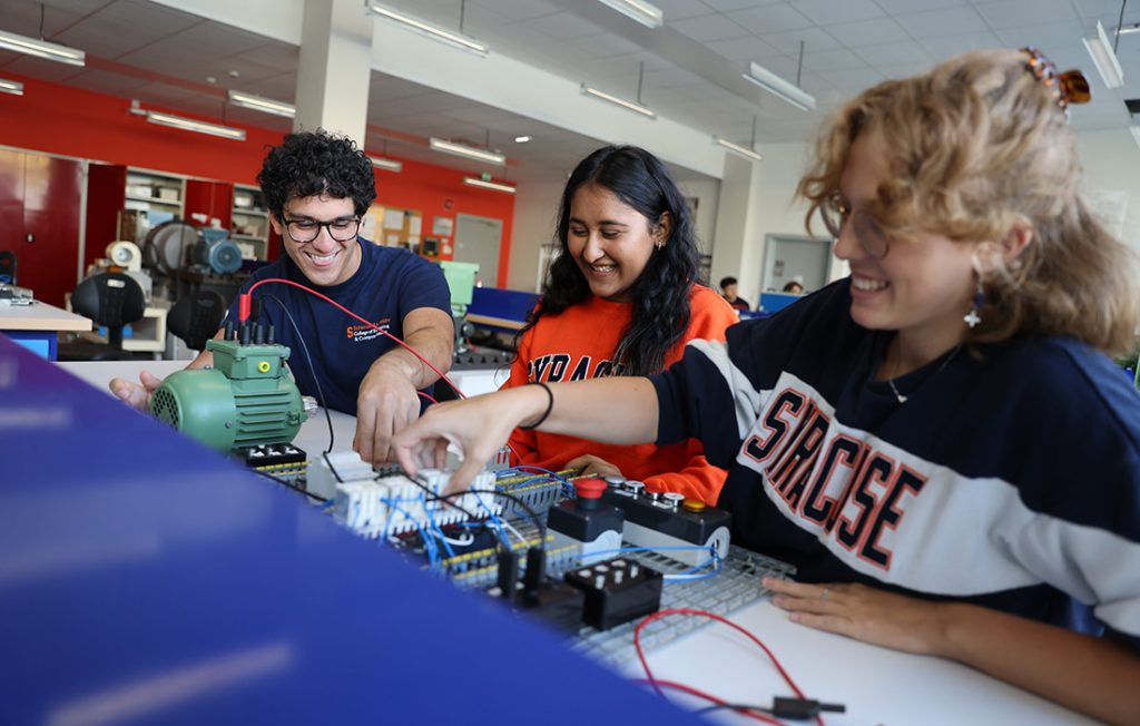 Three students working in an electrical engineering lab in Strasbourg, France