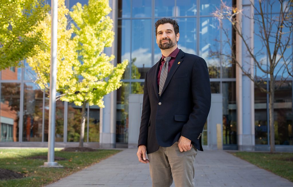 Professor Paulo Shakarian standing outside the Center for Science and Technology at Syracuse University