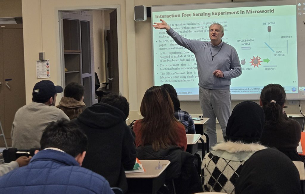Professor Mo Hasanovic giving a lecture on semiconductor and quantum technology during a Q SUCCEED event