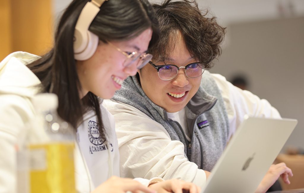 Students working on laptops during a cybersecurity competition 
