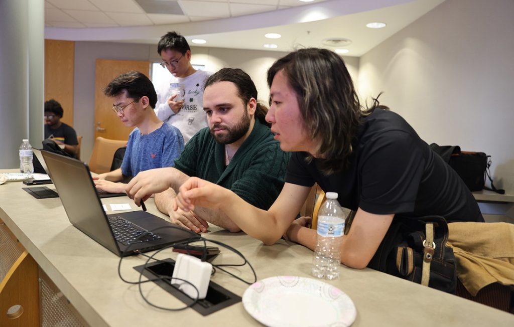 Students working on laptops during a cybersecurity competition 