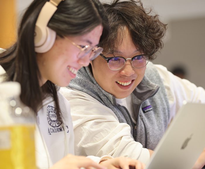 Students working on laptops during a cybersecurity competition
