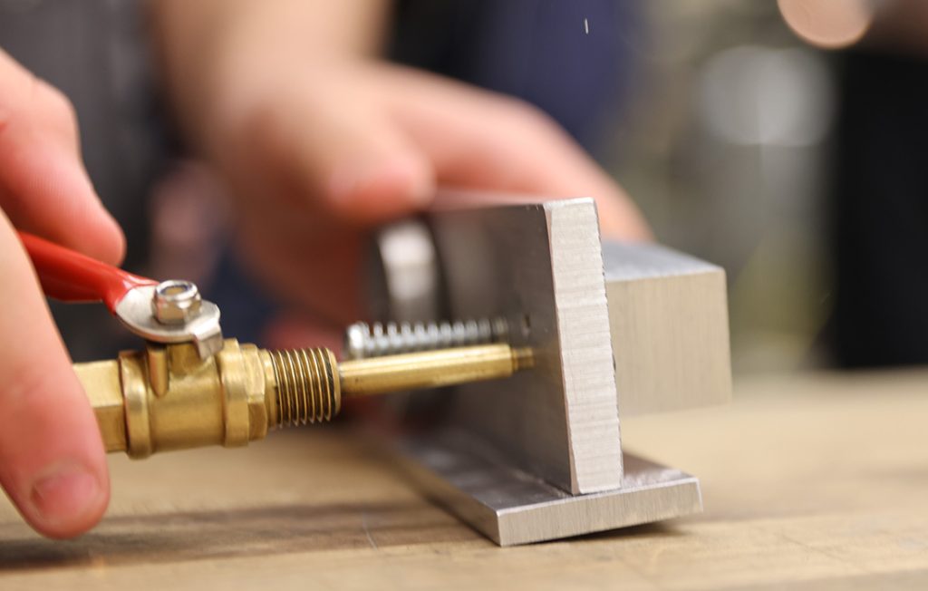 A close up of a compressed air hose going into an air engine