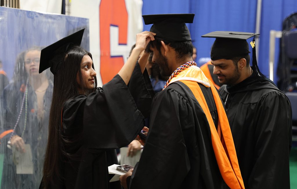 Students preparing for the 2026 Convocation by putting on caps and robes