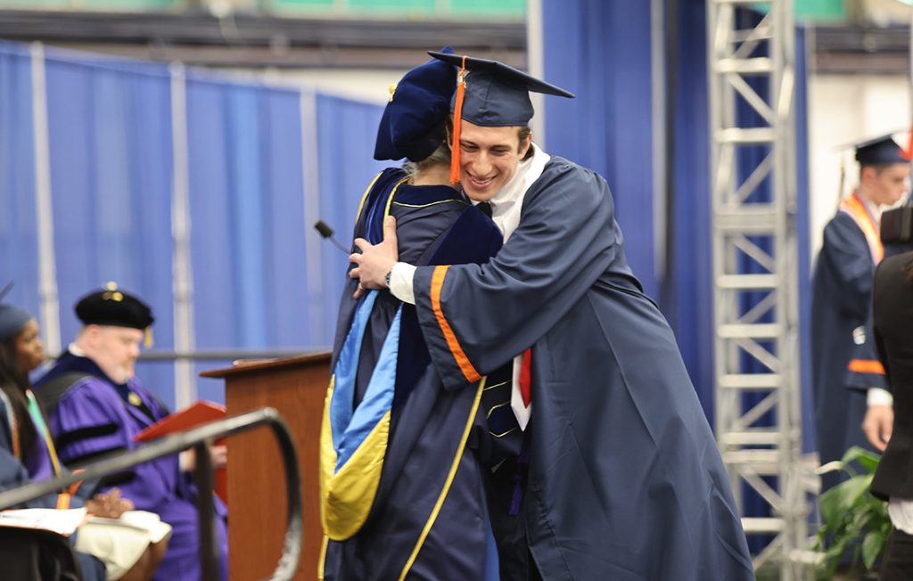 A student hugging Dean Ross at the Engineering and Computer Science Convocation