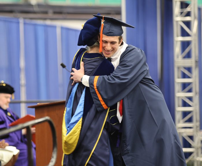 A student hugging Dean Ross at the Engineering and Computer Science Convocation