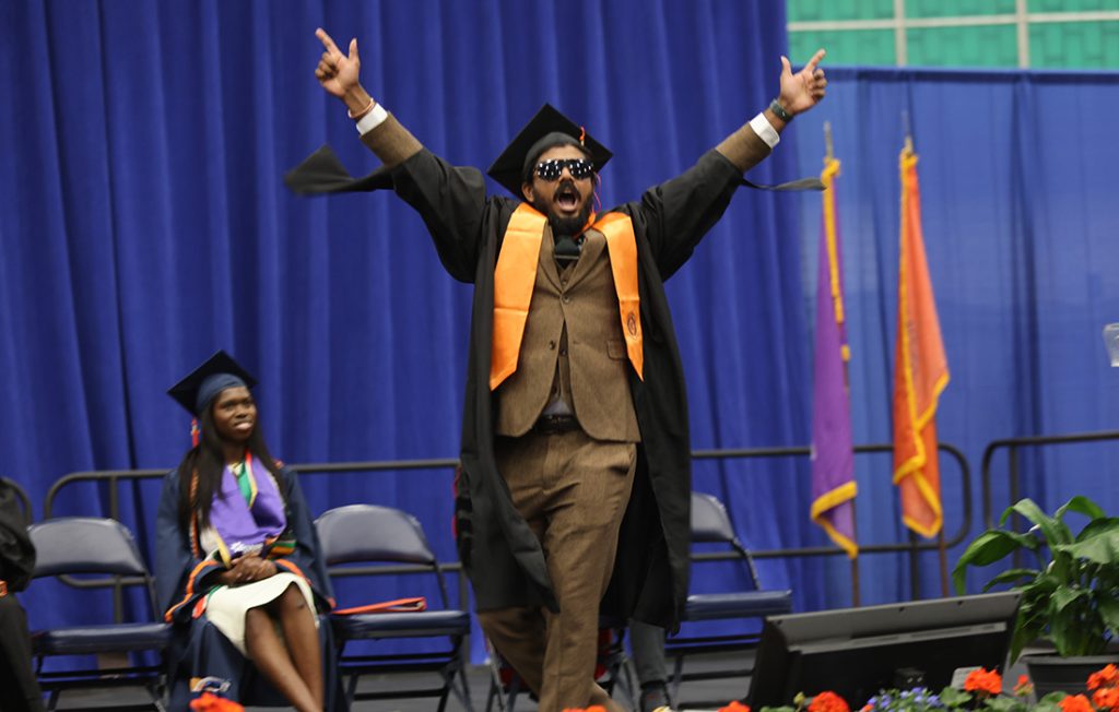 A student celebrating as they cross the stage at the 2026 Engineering and Computer Science Convocation
