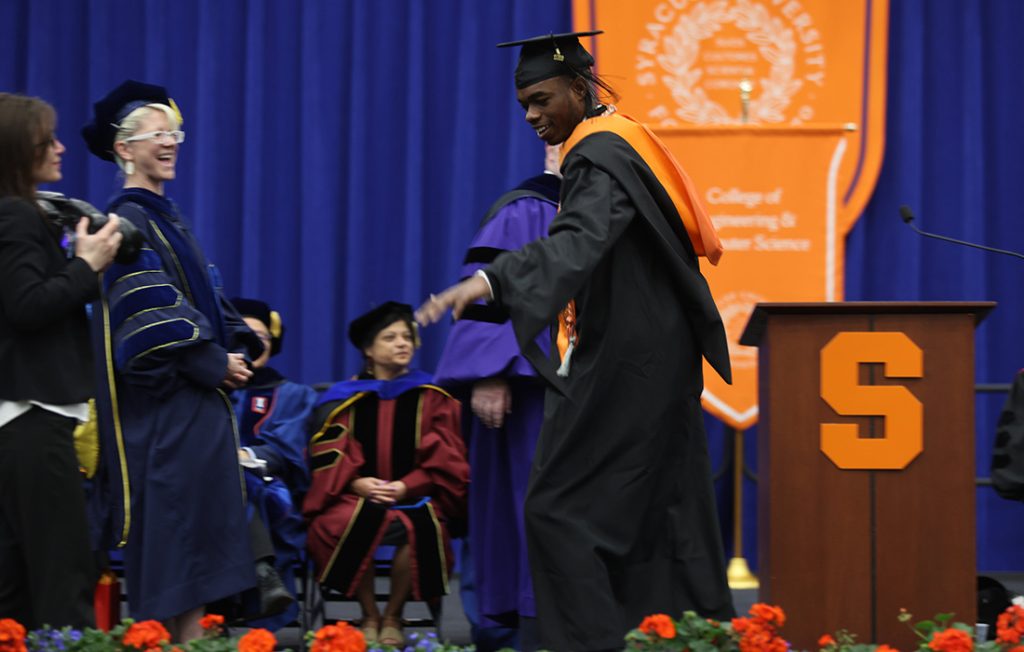 A student celebrating as they cross the stage at the 2026 Engineering and Computer Science Convocation
