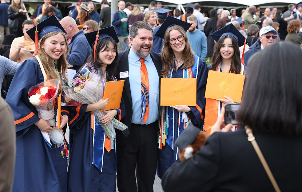 A group of students celebrating with their friends outside of the Engineering and Computer Science Convocation