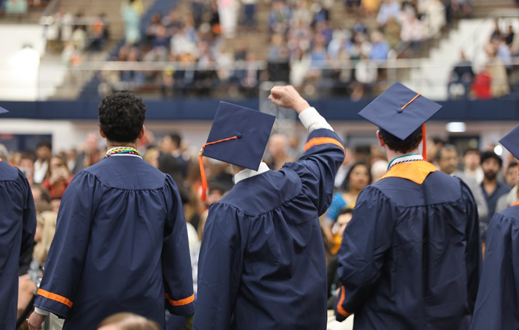 A student waving to their family at the 2026 Engineering and Computer Science Convocation