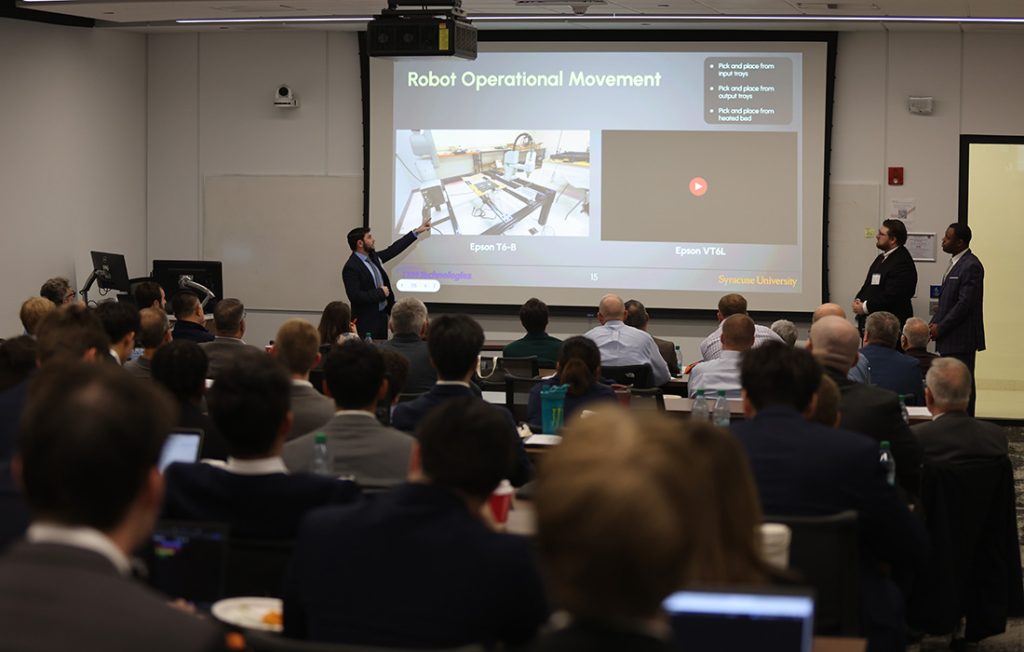Students presenting their final capstone designs to industry partners, faculty and fellow students