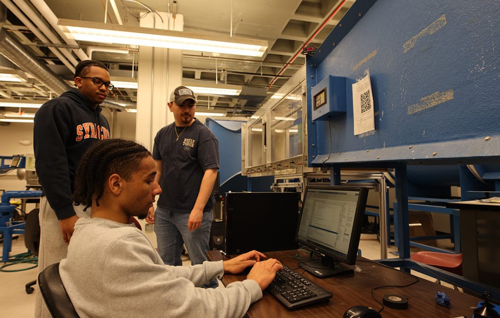 Students testing a prototype design in the sub-sonic wind tunnel