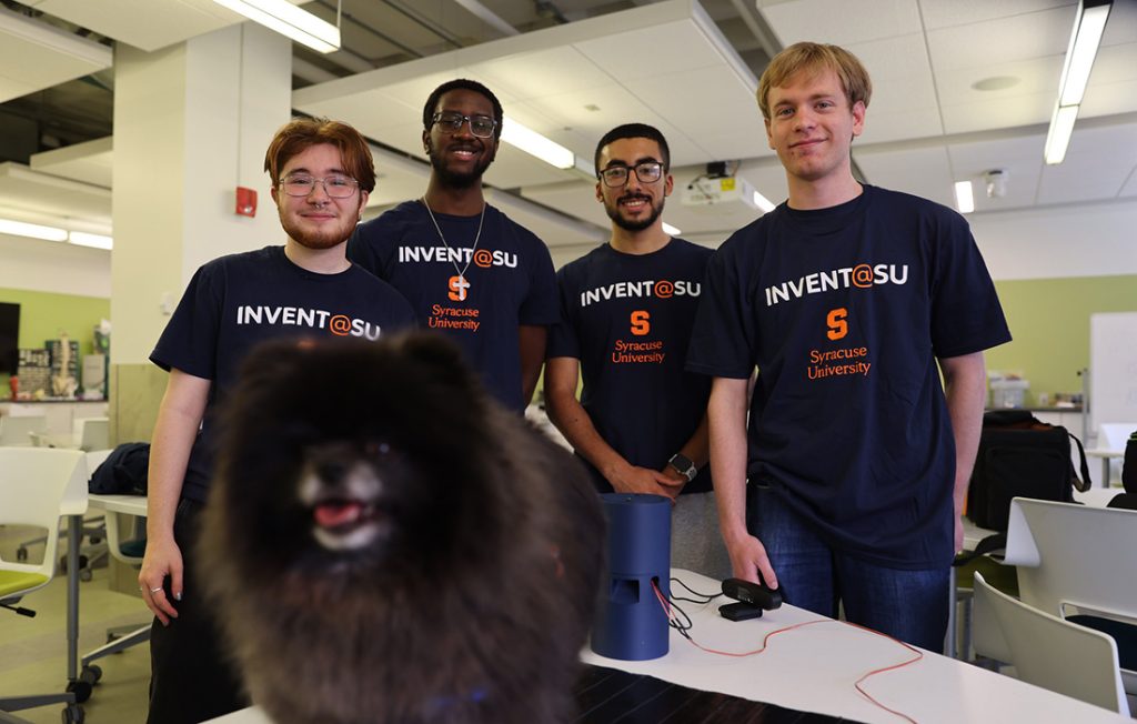 Team PawseMat with a small dog named Remus