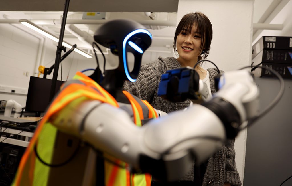 Yanxi Liu and a humanoid construction robot