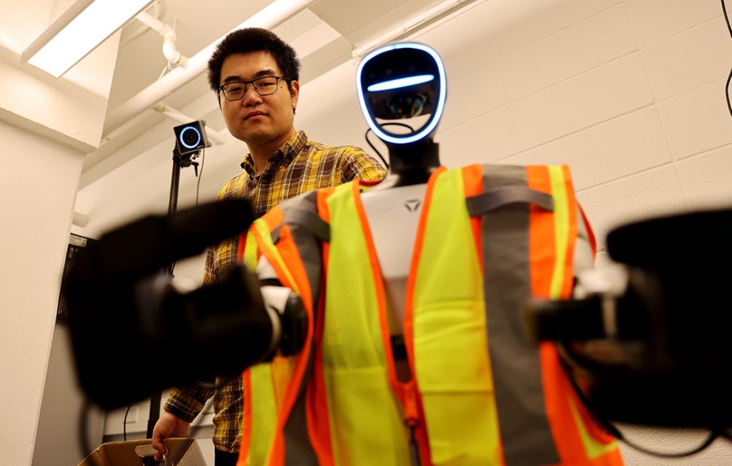 Professor Yizhi Liu and a humanoid construction robot