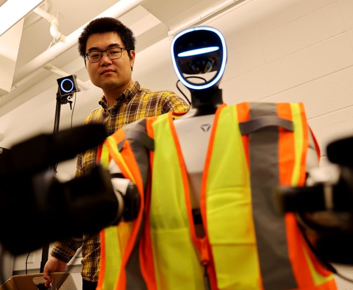 Professor Yizhi Liu and a humanoid construction robot